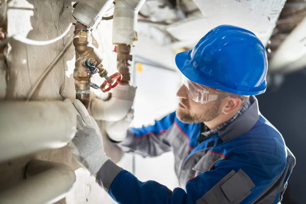 Worker Inspecting Water Valve