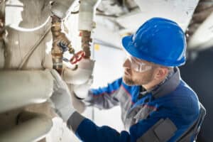 Worker Inspecting Water Valve